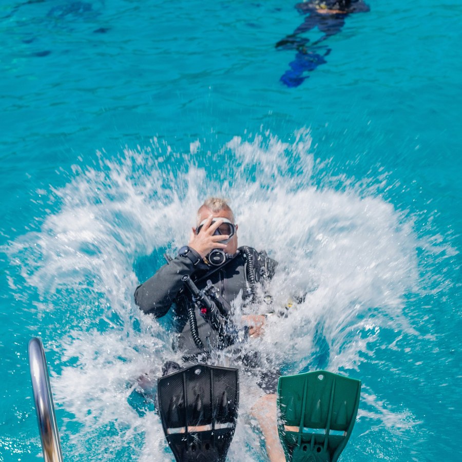 Diver jumping into the water from the boat