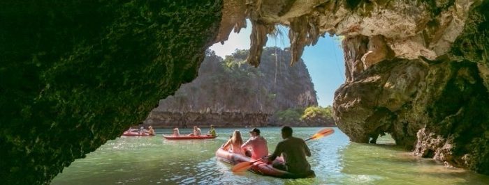 Canoeing through a sea cave at Hong Island