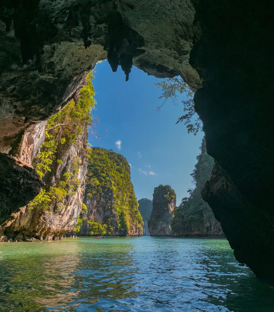 Paddling through a sea cave arch