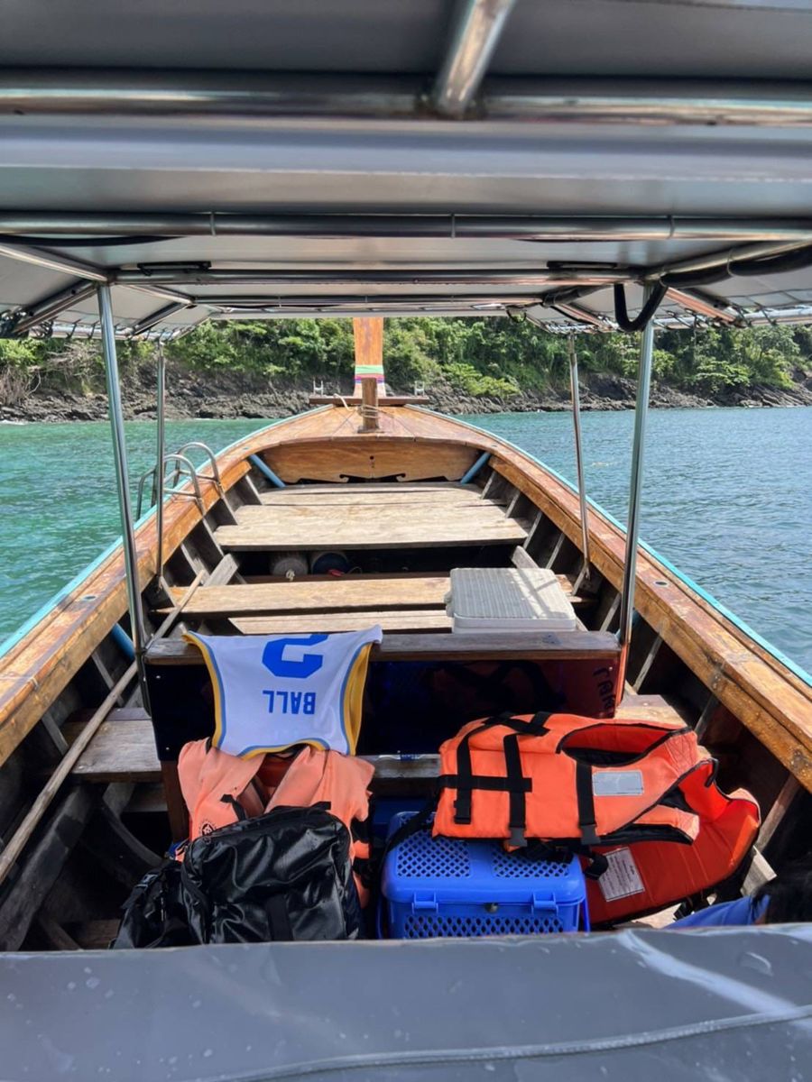 Inside the long-tail boat with shade roof and life jackets