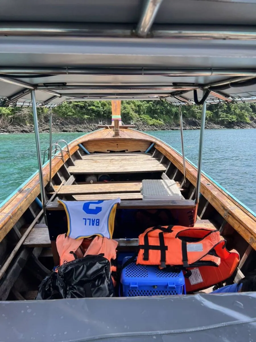 Inside the long-tail boat with shade roof and life jackets